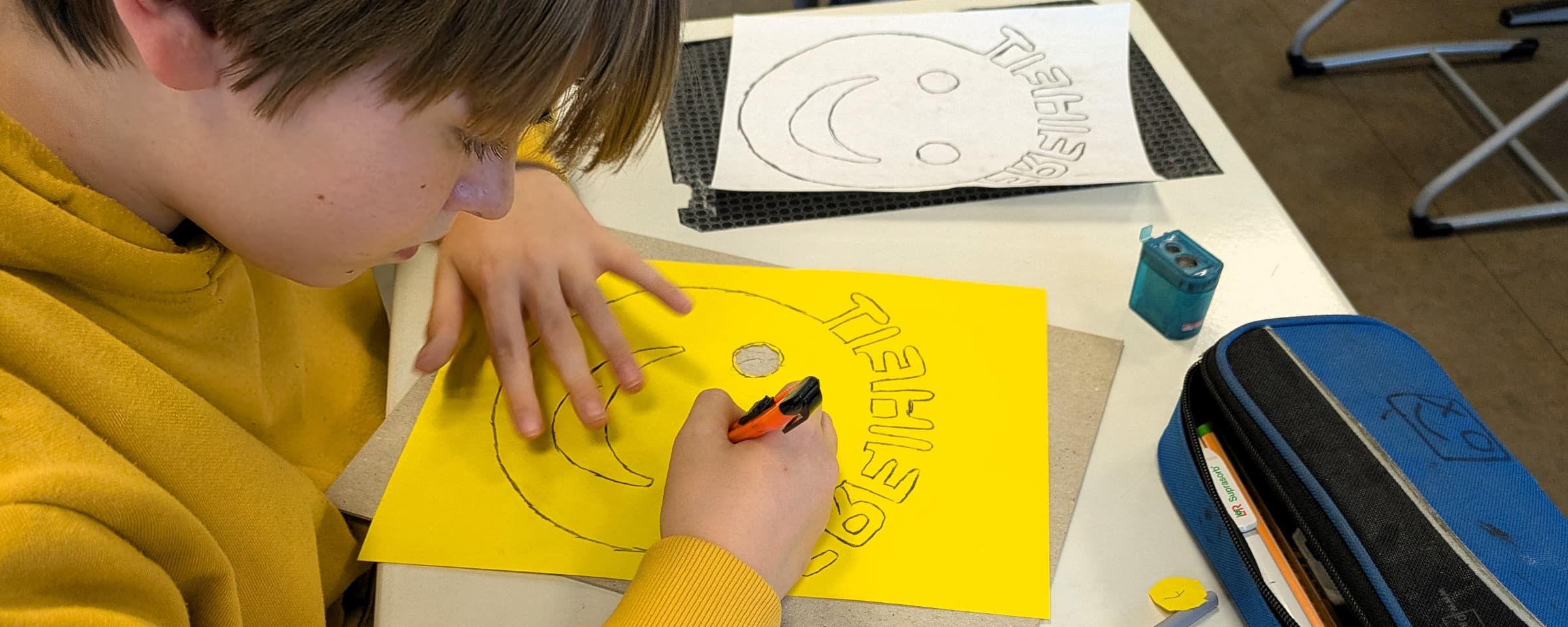 Ein Schüler beim Scherenschnitt